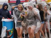 Reading Festival fans brave rain and mud as thunderstorms hit UK
