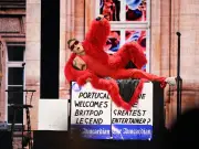 Robbie Williams channels Elmo in furry red outfit at Kalorama festival