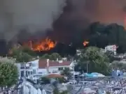 Tourists evacuated by boat as wildfires rage in Greece