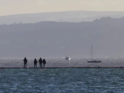 Body of man found on Merseyside lake rocks as death treated as unexplained