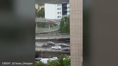 Driver sparks disbelief after red car mounts Glasgow footbridge