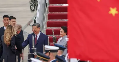 Trump greets Xi with rare airport handshake at start of state visit