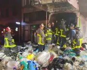 San Francisco firefighters rescue man trapped in garbage truck