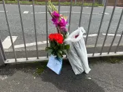 Tributes left at scene where woman died after being hit by taxi