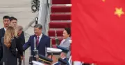 Trump greets Xi with rare airport handshake at start of state visit