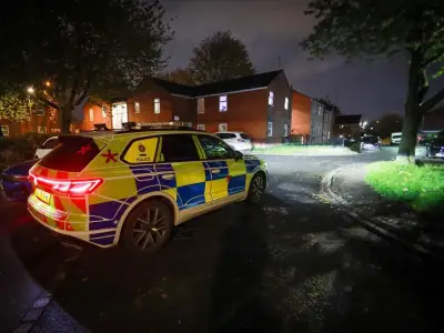 Armed police and helicopter at Oldham street scene