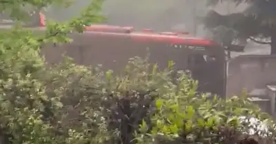 Bus swept away by mudslide in Chile as passengers cling to roof