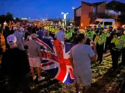 Far-right protesters clash with police after 149 migrants land in UK
