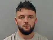 Father who drove off with police officer on bonnet jailed