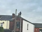 Hindley roof stand-off live as police surround terraced street