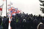 Hundreds join anti-migrant march near planned removal centre
