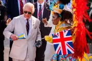 King Charles dances with maracas in Bahamas Junkanoo parade