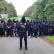 Police break up 100 masked anti-migrant protesters in Lancashire