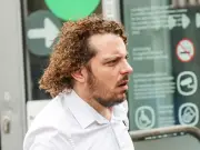 Thug who knifed ex's partner pictured with scratchcard after court