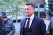 Tommy Robinson weeps in court during journalist harassment trial defence