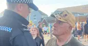 War veteran, 73, clashes with police over ID at UK migrant protest